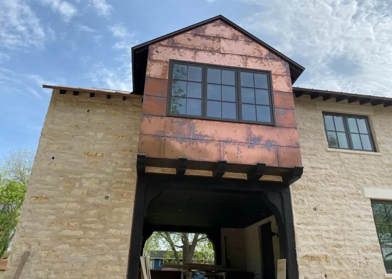 Copper metal panel facade on a stone building for Roof Repair in Woodway